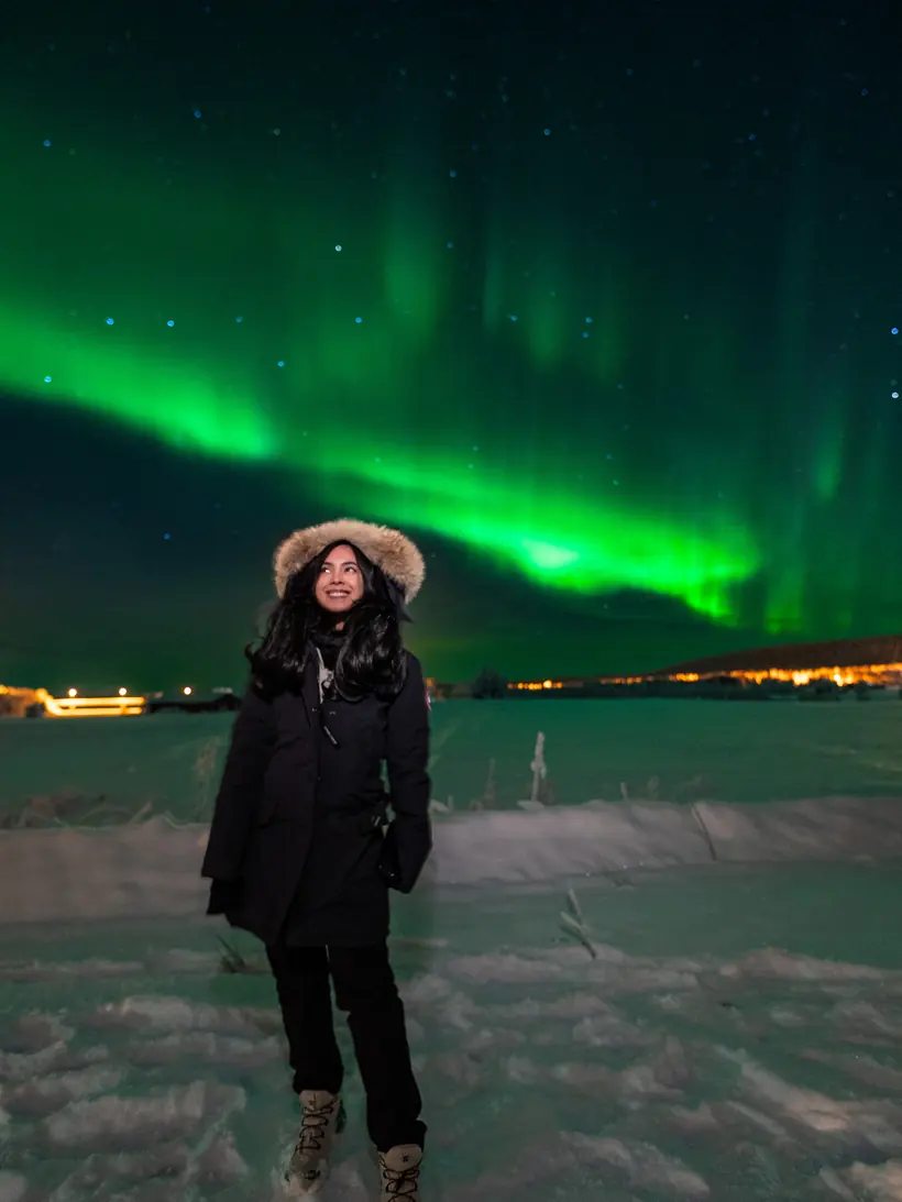 Northern lights over a snowy field near Rovaniemi