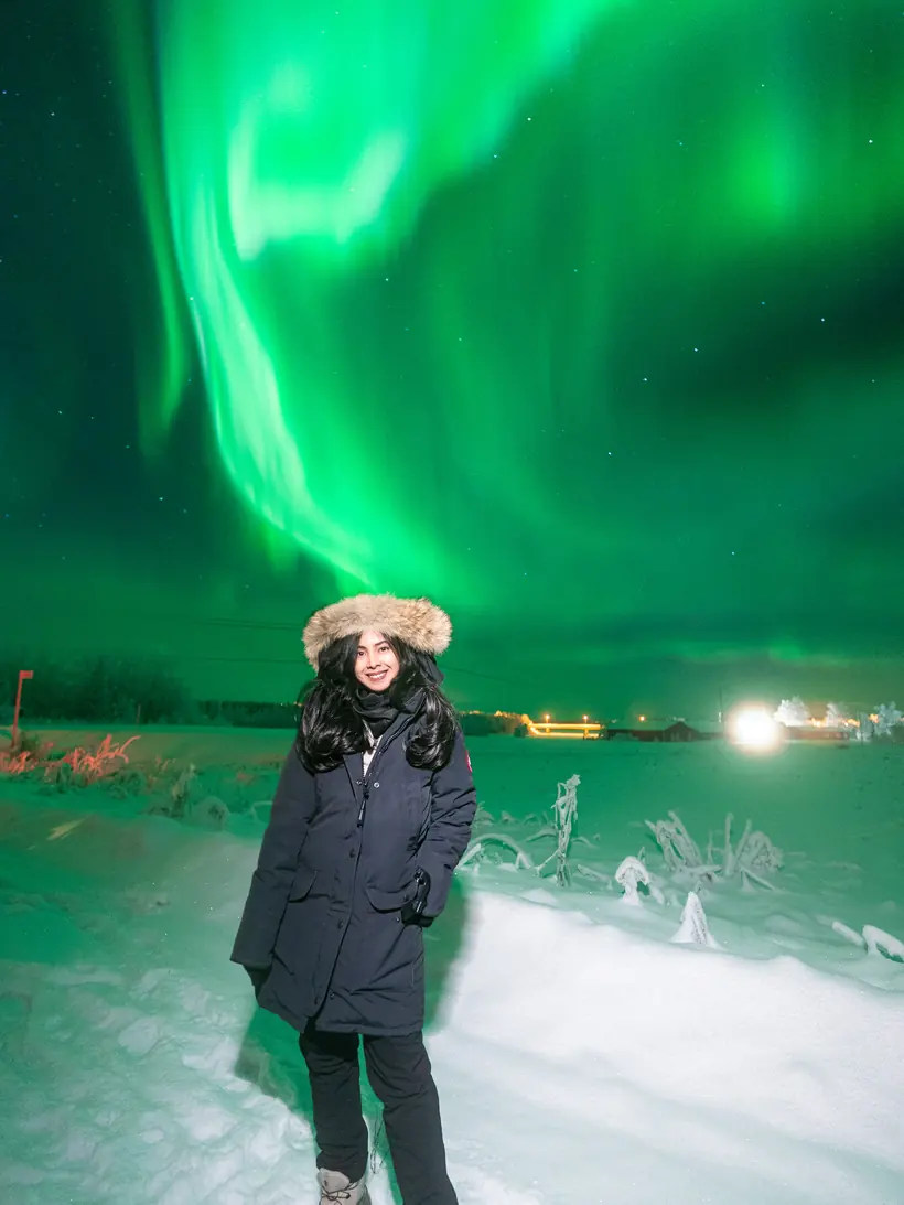Aurora borealis swirling overhead during northern lights chasing