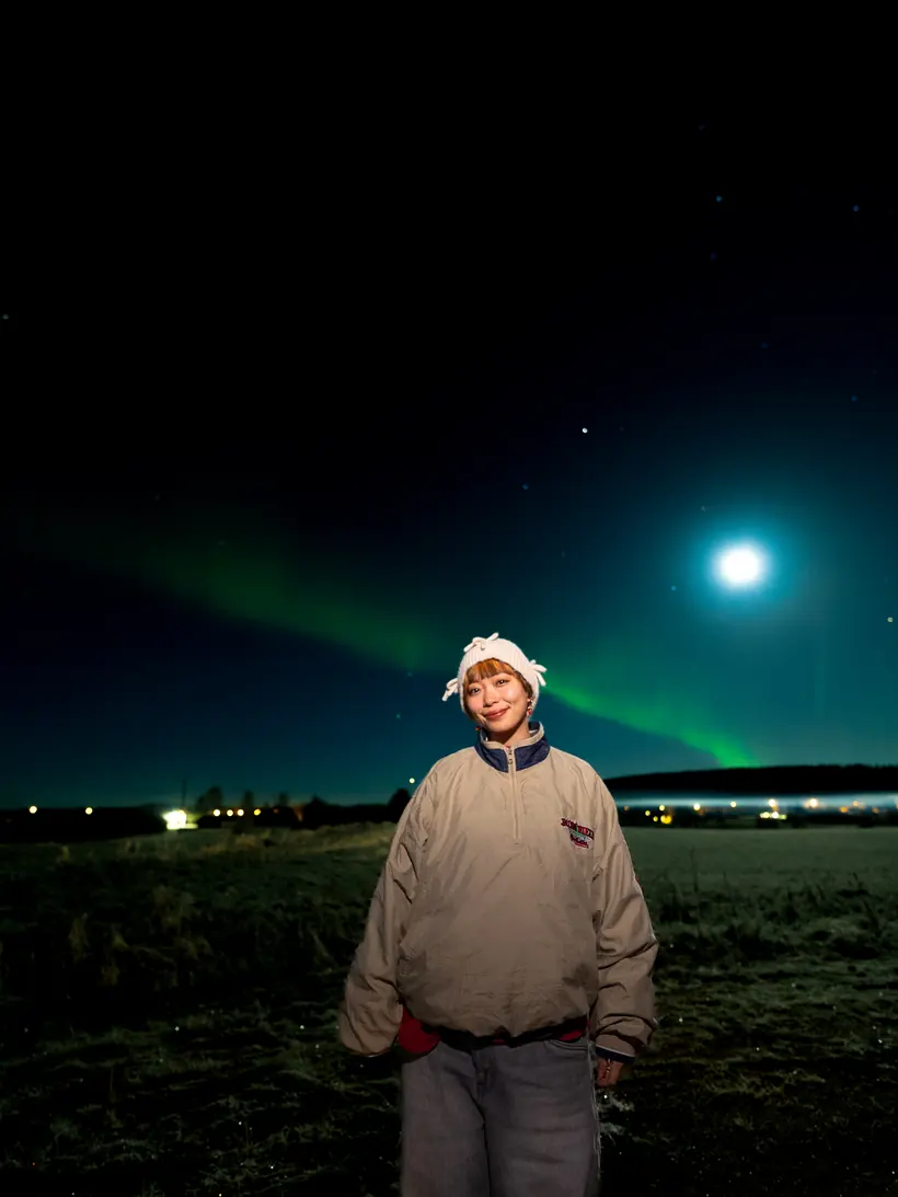 Guest under a faint aurora and full moon
